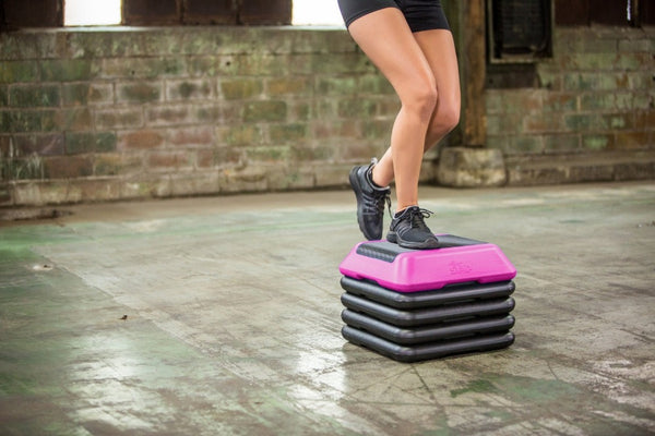 The Step High Step Platform With Four Riser from Lifeline Fitness for Step and Home in Pink compared to Total Fitness. 